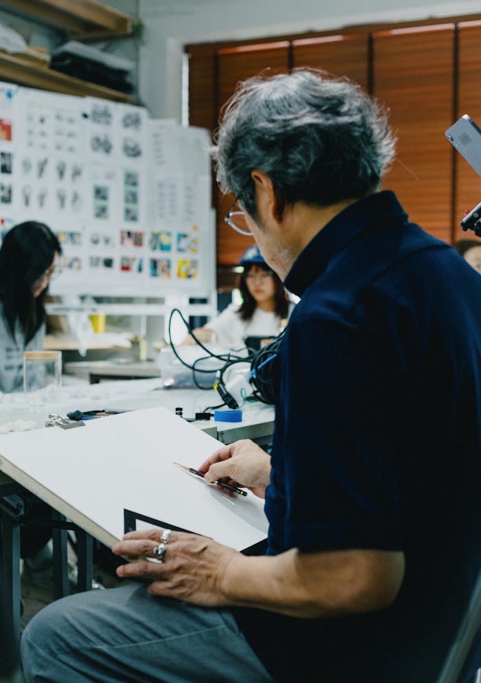 services-03 A lively art class in Shinjuku, Tokyo, showcasing creative interactions between students and teacher.